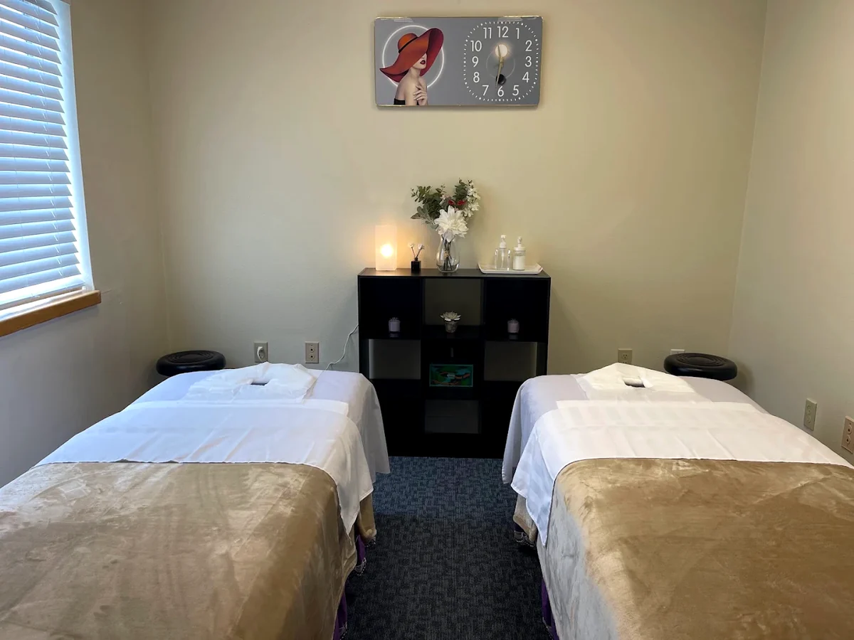 Couples massage room in Forest Grove, Oregon — two massage tables made up side by side in white linen at West Valley Massage